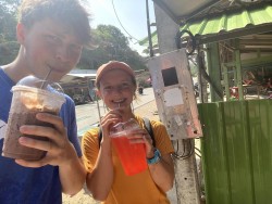 Shane and Addie complete task #12 - drink chai yen with a metal straw.
